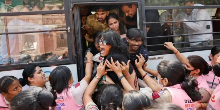 DETAINED protesters were driven away from the site in police buses in New Delhi. - PIC REUTERS
